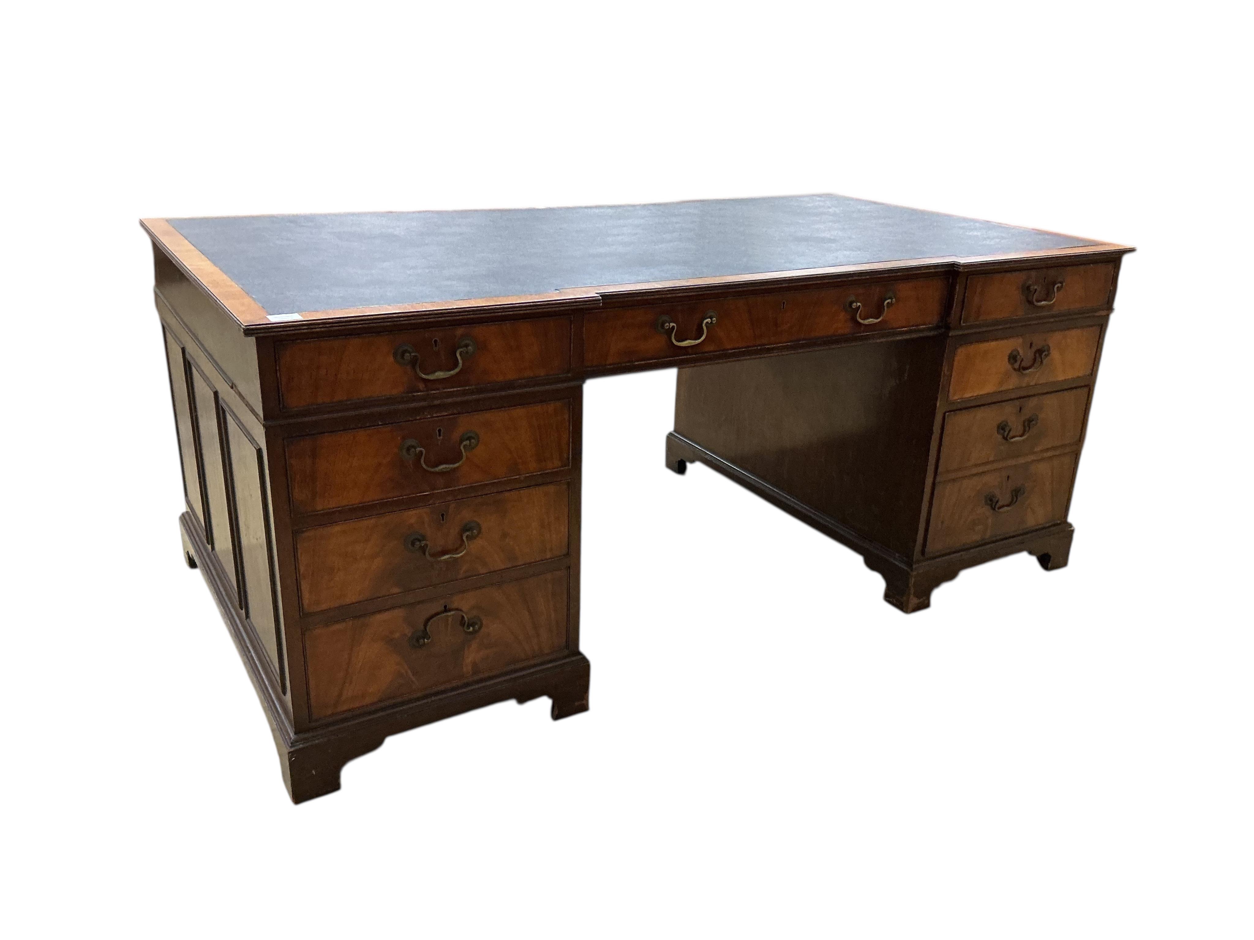 A reproduction George III style mahogany inverse breakfront pedestal desk, width 183cm, depth 99cm, height 76cm
